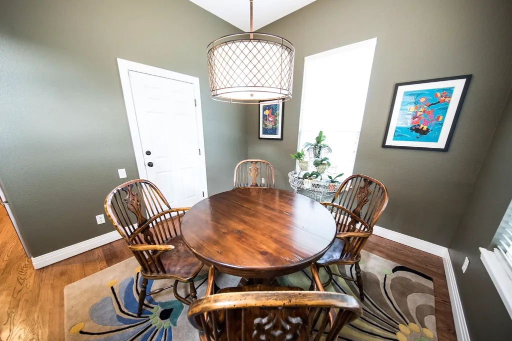 Shizen dining table — a solid oak round table with spindle chairs